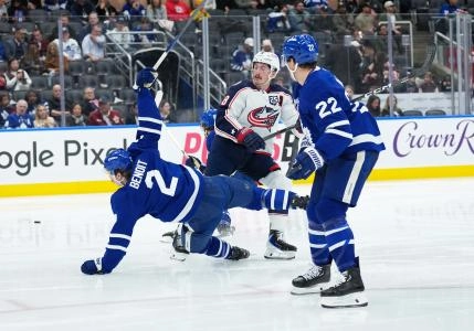 Nov 20, 2025; Toronto, Ontario, CAN; Toronto Maple Leafs defenseman Simon Benoit (2) battles for the puck with Columbus Blue Jackets defenseman Zach Werenski (8) during the second period at Scotiabank Arena. Mandatory Credit: Nick Turchiaro-Imagn Images