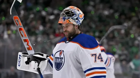Edmonton Oilers' Stuart Skinner spits during a game with his mask off
