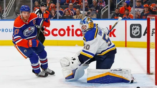 Edmonton Oilers' Connor McDavid skates in front of St. Louis Blues' Jordan Binnington