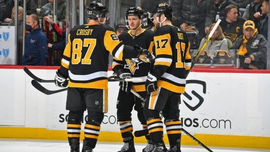 Pittsburgh Penguins players converge on the ice to have a chat