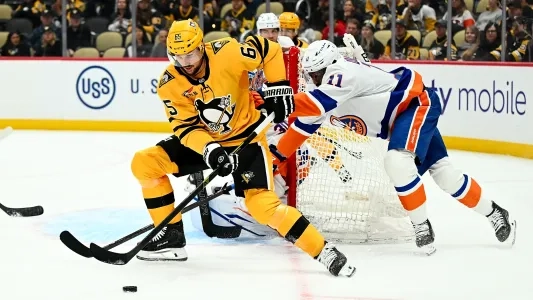 Pittsburgh Penguins' Erik Karlsson goes after the puck vs. the New York Islanders