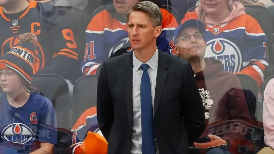 Edmonton Oilers head coach Kris Knoblauch stands behind the bench