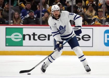 Dec 7, 2024; Pittsburgh, Pennsylvania, USA; Toronto Maple Leafs defenseman Chris Tanev (8) passes the puck against the Pittsburgh Penguins during the first period at PPG Paints Arena. Mandatory Credit: Charles LeClaire-Imagn Images