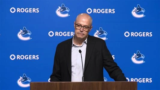 Vancouver Canucks GM Patrik Allvin listens to a question