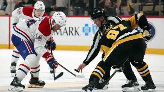 Linesman gets ready to drop the puck between the Pittsburgh Penguins and the Montreal Canadiens