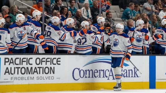 Edmonton Oilers' Max Jones celebrates a goal with his teammates on the bench