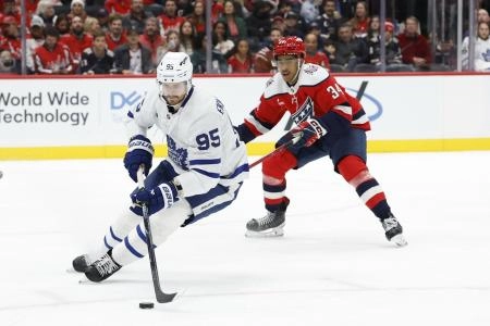 Nov 28, 2025; Washington, District of Columbia, USA; Toronto Maple Leafs defenseman Oliver Ekman-Larsson (95) skates with the puck as Washington Capitals right wing Justin Sourdif (34) chases during the third period at Capital One Arena