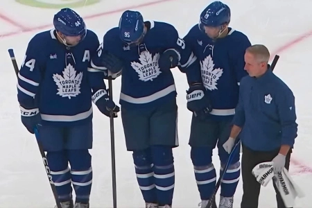 Maple Leafs defenseman Oliver Ekman-Larsson is helped off the ice after suffering an injury during a game vs. the San Jose Sharks on Thursday night.