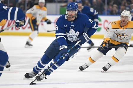 Oct 14, 2025; Toronto, Ontario, CAN; Toronto Maple Leafs defenseman Chris Tanev (8) skates with the puck against the Nashville Predators in the second period at Scotiabank Arena.