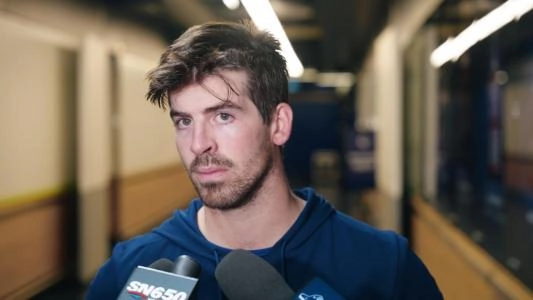 Vancouver Canucks' Conor Garland speaks to a reporter