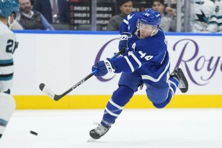 Dec 11, 2025; Toronto, Ontario, CAN; Toronto Maple Leafs defenseman Morgan Rielly (44) shoots the puck against the San Jose Sharks during the third period at Scotiabank Arena.