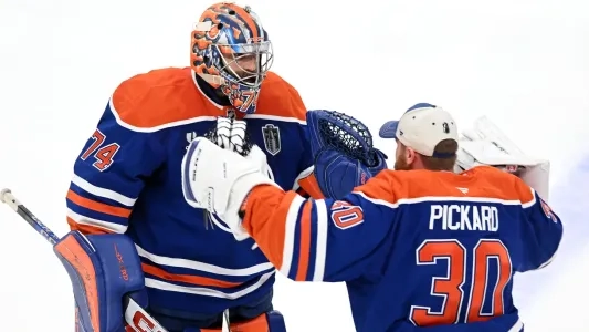 Edmonton Oilers' Calvin Pickard goes in to hug Stuart Skinner