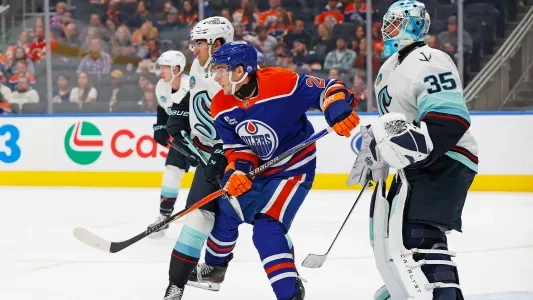 Edmonton Oilers' Quinn Hutson in front of the Seattle Kraken net