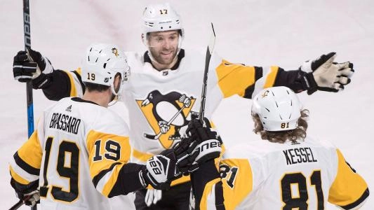 Pittsburgh Penguins players celebrate a goal together