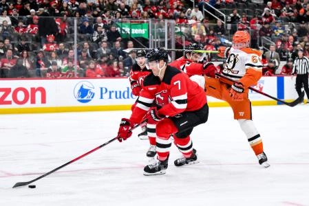 Dec 13, 2025; Newark, New Jersey, USA; New Jersey Devils defenseman Dougie Hamilton (7) skates with the puck as defenseman Jonas Siegenthaler (71) checks Anaheim Ducks center Mikael Granlund (64) during the third period at Prudential Center.