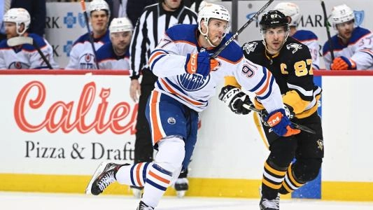 Edmonton Oilers' Connor McDavid battles Pittsburgh Penguins' Sidney Crosby