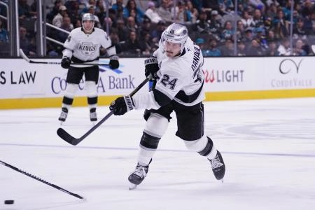 Nov 20, 2025; San Jose, California, USA; Los Angeles Kings center Phillip Danault (24) takes a shot on goal against the San Jose Sharks in the second period at SAP Center at San Jose.