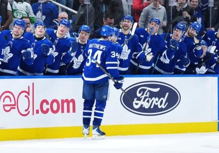 Dec 16, 2025; Toronto, Ontario, CAN; Toronto Maple Leafs center Auston Matthews (34) celebrates at the bench after scoring a goal against the Chicago Blackhawks during the third period at Scotiabank Arena.