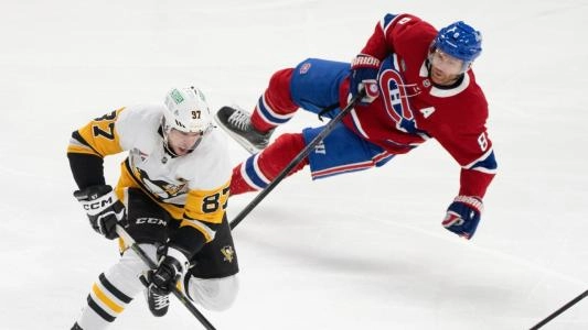 Pittsburgh Penguins' Sidney Crosby skates by Montreal Canadiens' Mike Matheson
