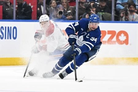 Dec 6, 2025; Toronto, Ontario, CAN; Toronto Maple Leafs forward Auston Matthews (34) stickhandles past Montreal Canadiens forward Ivan Demidov (93) in overtime at Scotiabank Arena