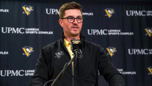 Pittsburgh Penguins' Kyle Dubas smirks as he speaks to reporters