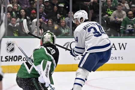 Dec 21, 2025; Dallas, Texas, USA; Dallas Stars goaltender Jake Oettinger (29) makes a glove save on a shot by Toronto Maple Leafs center Auston Matthews (34) during the first period at the American Airlines Center