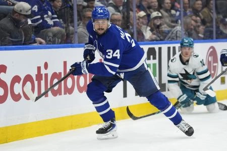 Dec 11, 2025; Toronto, Ontario, CAN; Toronto Maple Leafs forward Auston Matthews (34) chases after the puck as San Jose Sharks forward Ty Dellandrea (10) looks on during the second period at Scotiabank Arena. Mandatory Credit: John E. Sokolowski-Imagn Images