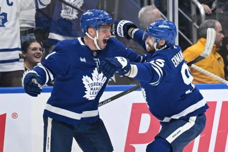 Dec 23, 2025; Toronto, Ontario, CAN; Toronto Maple Leafs forward Max Domi (11) celebrates with defenseman Oliver Ekman-Larsson (95) after scoring a goal against the Pittsburgh Penguins in the third period at Scotiabank Arena.