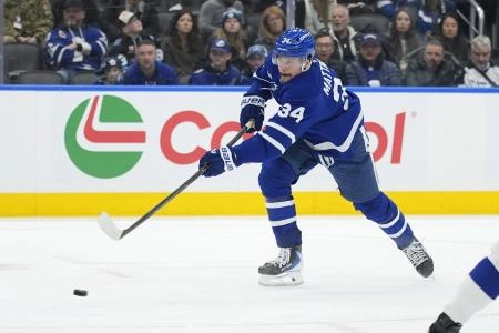 Dec 8, 2025; Toronto, Ontario, CAN; Toronto Maple Leafs forward Auston Matthews (34) shoots the puck against the Tampa Bay Lightning during the third period at Scotiabank Arena.