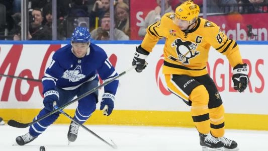 Pittsburgh Penguins' Sidney Crosby skates alongside the Toronto Maple Leafs