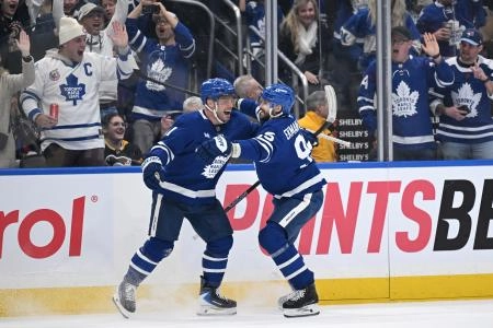 Dec 23, 2025; Toronto, Ontario, CAN; Toronto Maple Leafs forward Max Domi (11) celebrates with defenseman Oliver Ekman-Larsson (95) after scoring a goal against the Pittsburgh Penguins in the third period at Scotiabank Arena.