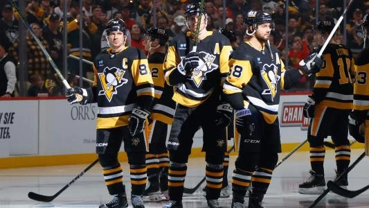 Pittsburgh Penguins players salute the crowd