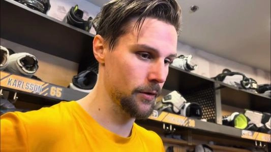 Pittsburgh Penguins' Erik Karlsson speaks to reporters in the locker room