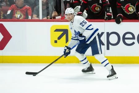Apr 26, 2025; Ottawa, Ontario, CAN; Toronto Maple Leafs defenseman Brandon Carlo (25) controls the puck in game four of the first round of the 2025 Stanley Cup Playoffs against the Ottawa Senators at the Canadian Tire Centre. Mandatory Credit: Marc DesRosiers-Imagn Images