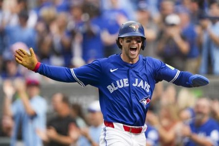 Sep 27, 2025; Toronto, Ontario, CAN; Toronto Blue Jays third base Ernie Clement (22) celebrates after scoring against the Tampa Bay Rays during the second inning at Rogers Centre. Mandatory Credit: Kevin Sousa-Imagn Images