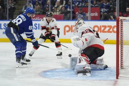 Dec 27, 2025; Toronto, Ontario, CAN; Toronto Maple Leafs forward William Nylander (88) scores on Ottawa Senators goaltender Linus Ullmark (35) as defenseman Jake Sanderson (85) looks on during the first period at Scotiabank Arena