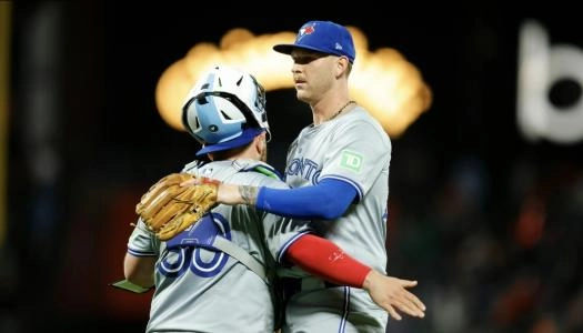 Jul 10, 2024; San Francisco, California, USA; Toronto Blue Jays pitcher Bowden Francis (44) celebrates with catcher Alejandro Kirk (30) after a game against the San Francisco Giants at Oracle Park. Mandatory Credit: Sergio Estrada-Imagn Images