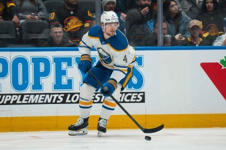 Dec 11, 2025; Vancouver, British Columbia, CAN; Buffalo Sabres defenseman Bowen Byram (4) handles the puck against the Vancouver Canucks in the first period at Rogers Arena.