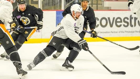 Pittsburgh Penguins' Erik Karlsson skates with the puck at practice