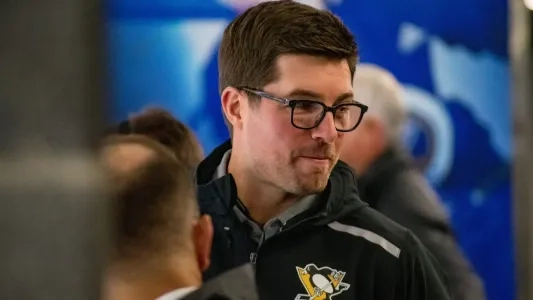 Pittsburgh Penguins GM Kyle Dubas with a smirk looking sideways