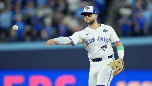 Nov 1, 2025; Toronto, Ontario, CAN; Toronto Blue Jays designated hitter Bo Bichette (11) throws to first for an out against Los Angeles Dodgers second baseman Tommy Edman (25) in the eighth inning during game seven of the 2025 MLB World Series at Rogers Centre. Mandatory Credit: John E. Sokolowski-Imagn Images