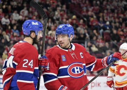 7 janvier 2026; Montr&eacute;al, Qu&eacute;bec, Canada; L'attaquant des Canadiens de Montr&eacute;al, Philip Danault (24), et son co&eacute;quipier Nick Suzuki (14) se pr&eacute;parent pour une mise au jeu contre les Flames de Calgary durant la troisi&egrave;me p&eacute;riode au Centre Bell.