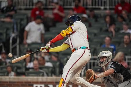 Aug 20, 2025; Cumberland, Georgia, USA; Atlanta Braves designated hitter Marcell Ozuna (20) hits a double against the Chicago White Sox during the fourth inning at Truist Park.