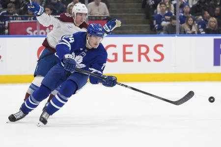 Jan 25, 2026; Toronto, Ontario, CAN; Toronto Maple Leafs forward Bobby McMann (74) passes the puck against the Colorado Avalanche during the second period at Scotiabank Arena.