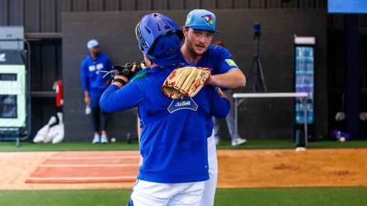 Toronto Blue Jays rookie pitcher Trey Yesavage and catcher Alejandro Kirk share a hug after finishing a bullpen together.