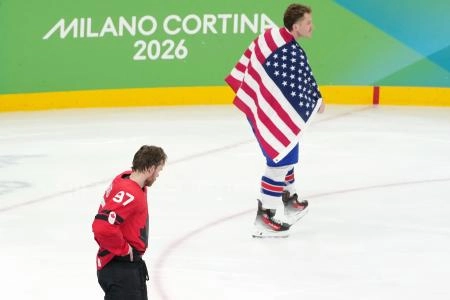 Feb 22, 2026; Milan, Italy; Matthew Tkachuk of the United States and Connor McDavid of Canada reacts after the mens ice hockey gold medal game during the Milano Cortina 2026 Olympic Winter Games at Milano Santagiulia Ice Hockey Arena. Mandatory Credit: James Lang-Imagn Images