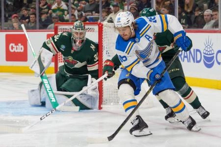 Mar 1, 2026; Saint Paul, Minnesota, USA; St. Louis Blues center Robert Thomas (18) attempts a wrap around on Minnesota Wild goaltender Filip Gustavsson (32) in the third period at Grand Casino Arena. Mandatory Credit: Matt Blewett-Imagn Images