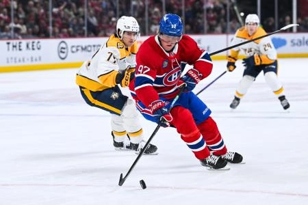 Oct 16, 2025; Montreal, Quebec, CAN; Montreal Canadiens right wing Patrik Laine (92) defends the puck against Nashville Predators right wing Luke Evangelista (77) during the first period at Bell Centre.