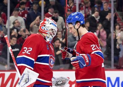 Jan 7, 2026; Montreal, Quebec, CAN; Montreal Canadiens goalie Jacob Fowler (32) celebrates the win against the Calgary Flames with teammate forward Juraj Slafkovsky (20) at the Bell Centre.