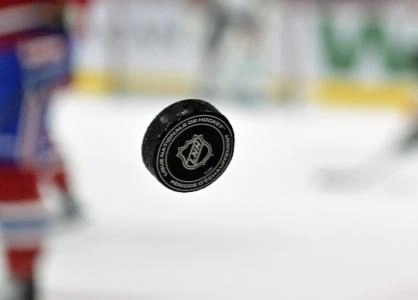Apr 5, 2025; Montreal, Quebec, CAN; French logo on an NHL puck during the warmup period before the game between the Philadelphia Flyers and the Montreal Canadiens at the Bell Centre.